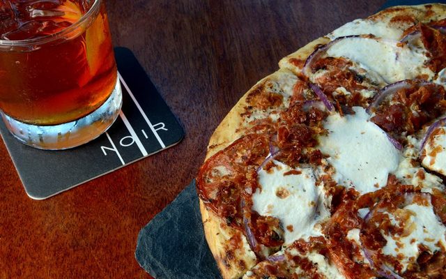 A cocktail and flat-bread pizza