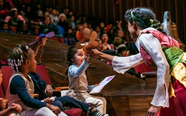Janiah Lockett in Thumbelina with audience members.