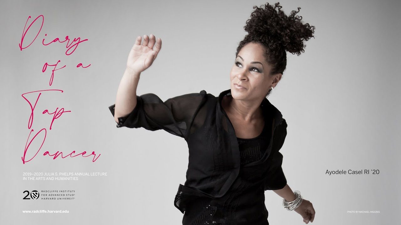 Ayodele Casel in front of a white backdrop.