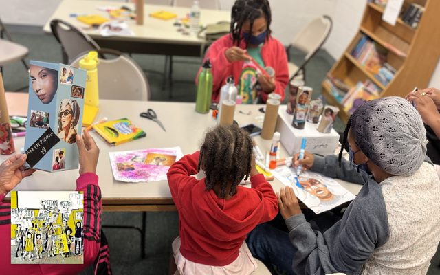 Kids doing crafts at a table.