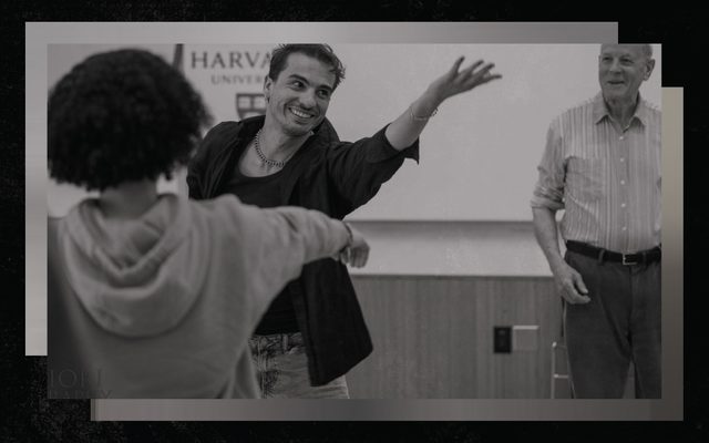 A young mean reaches towards the ceiling while smiling
