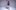 Ayodele Casel in a sparkly jacket lefts one leg in front of a studio background.